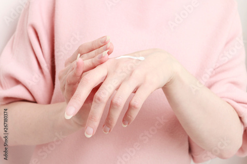 Woman rubbing cream in her hands