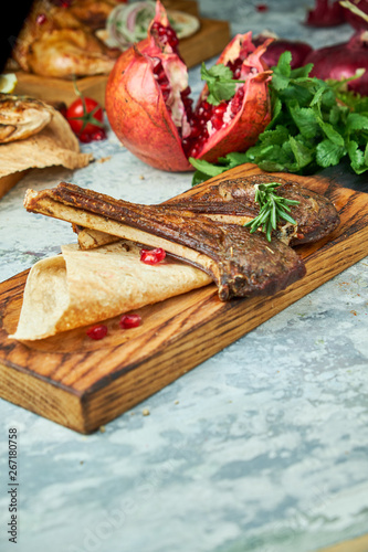 Wooden board with meat from a barbecue,