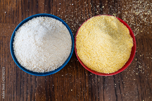 Two bowls of yellow and white Nigerian Garri on Table photo