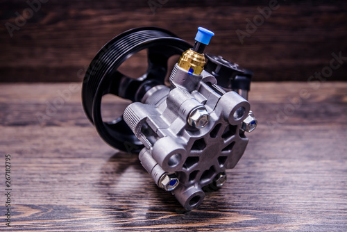 Power steering pump on wooden background