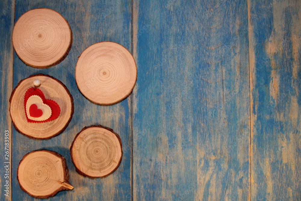 beautiful red heart is nailed to a wooden saw cut on blue wooden boards beautiful red heart is nailed to a wooden saw cut on blue wooden boards