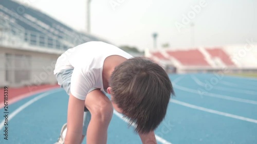 Close up slow motion young Asian boy prepare to run and look forward