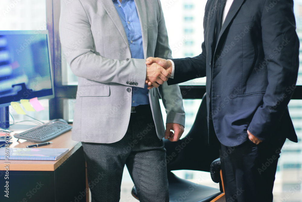 Businessmen making handshake in office business building