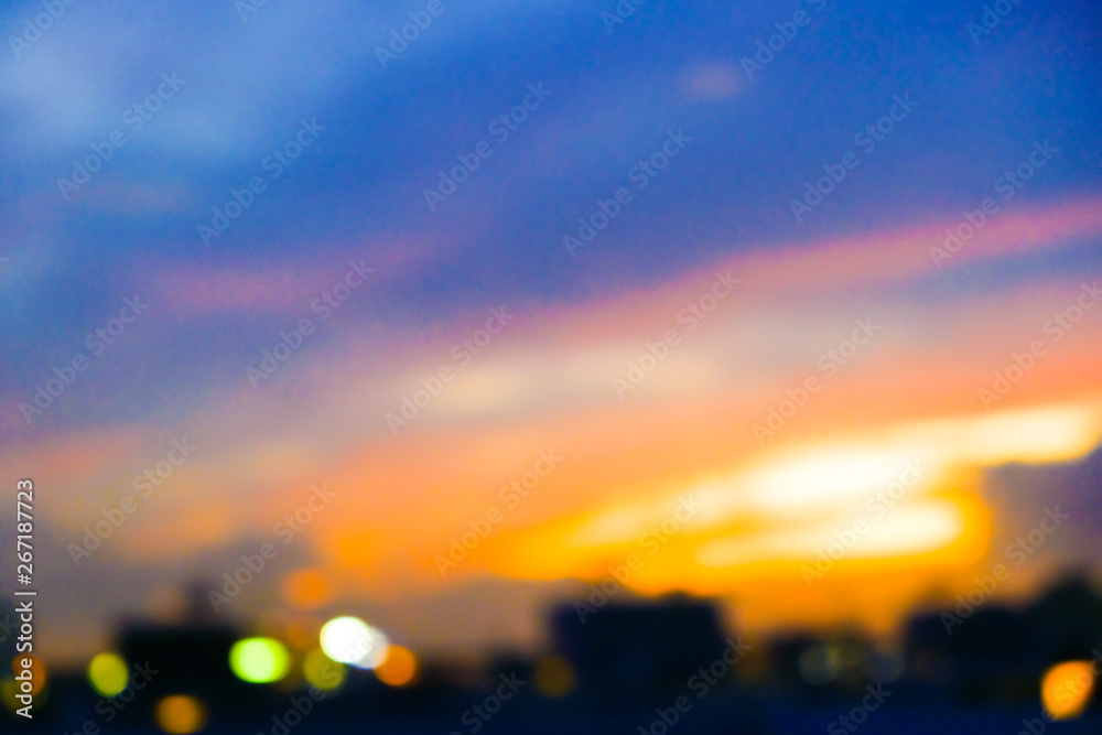 Fototapeta premium Blurred colorful sunset sky cloud with city building