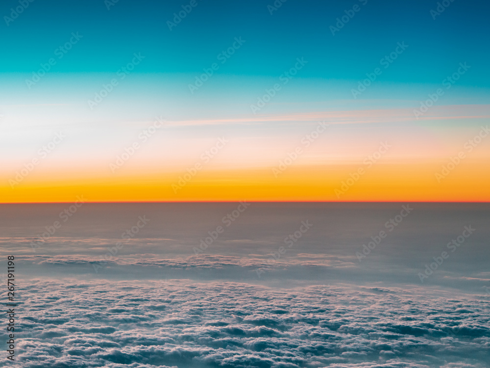 Fototapeta premium Beautiful blue sky and clouds before sunrise in Taiwan. Amazing landscape view from airplane window.