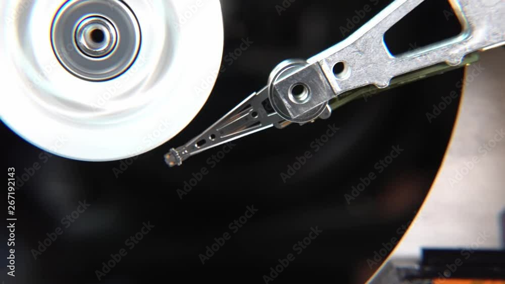 Close-up of an operating computer harddisk reading and writing data Close-up of an operating computer harddisk reading and writing data