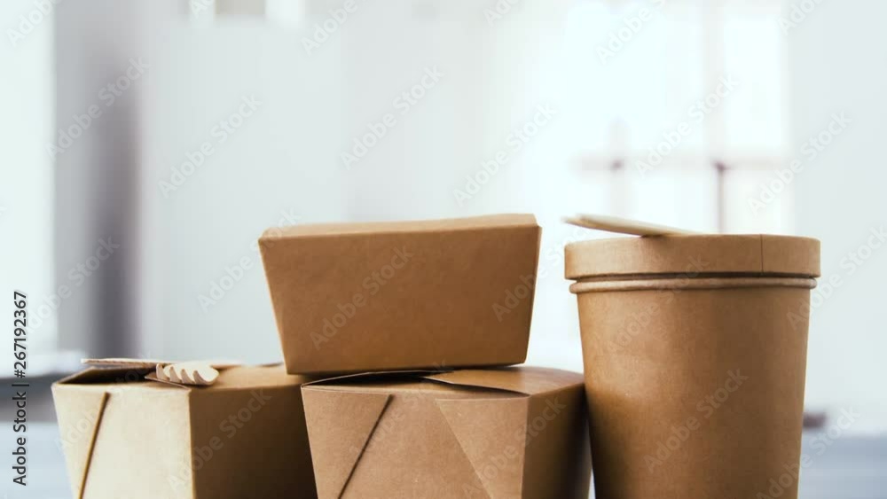 package, recycling and eating concept - disposable paper containers for takeaway food on table