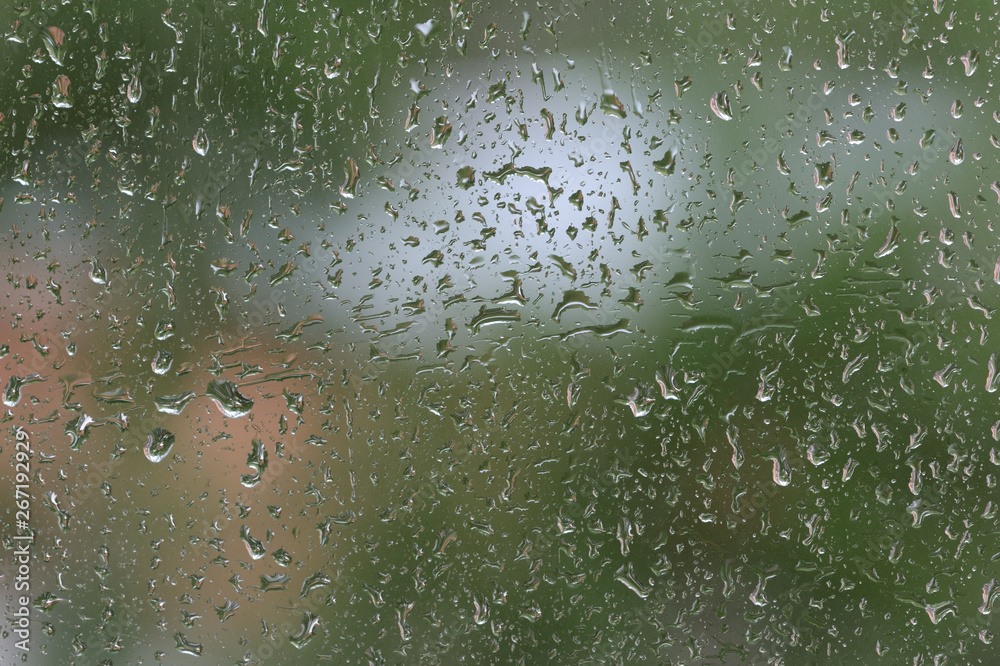 Raindrops on window glass during the rain close up. Natural background Raindrops on window glass during the rain close up. Natural background