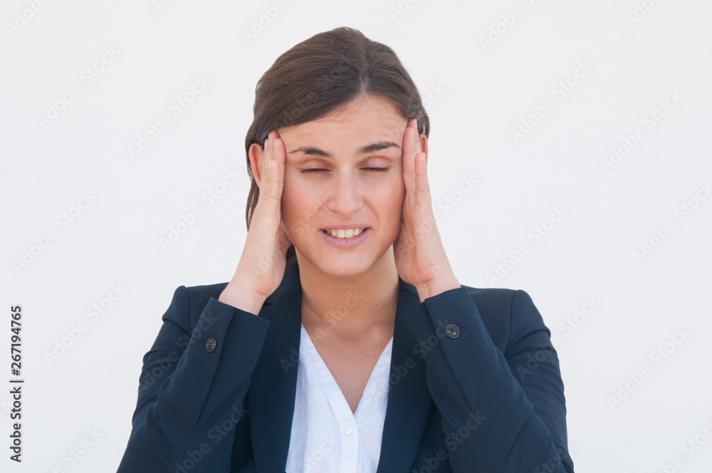 Tired young business lady trying to concentrate. Young woman in office jacket suffering from headache. Headache concept Tired young business lady trying to concentrate. Young woman in office jacket suffering from headache. Headache concept