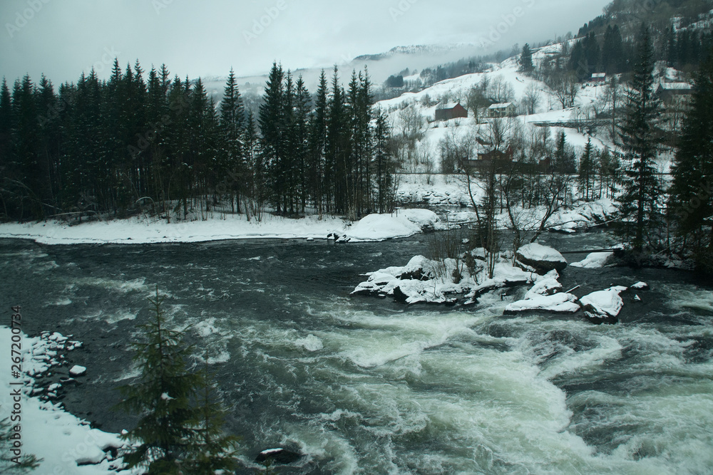 Southern Norway, winter landscape with river rapids