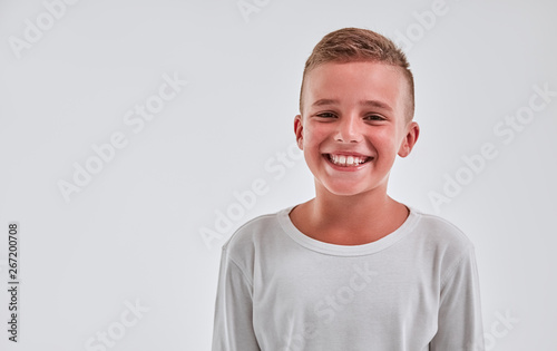 Cute boy on a gray background photo