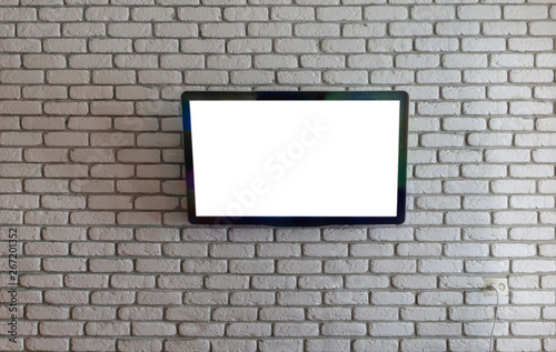 TV on a white brick wall