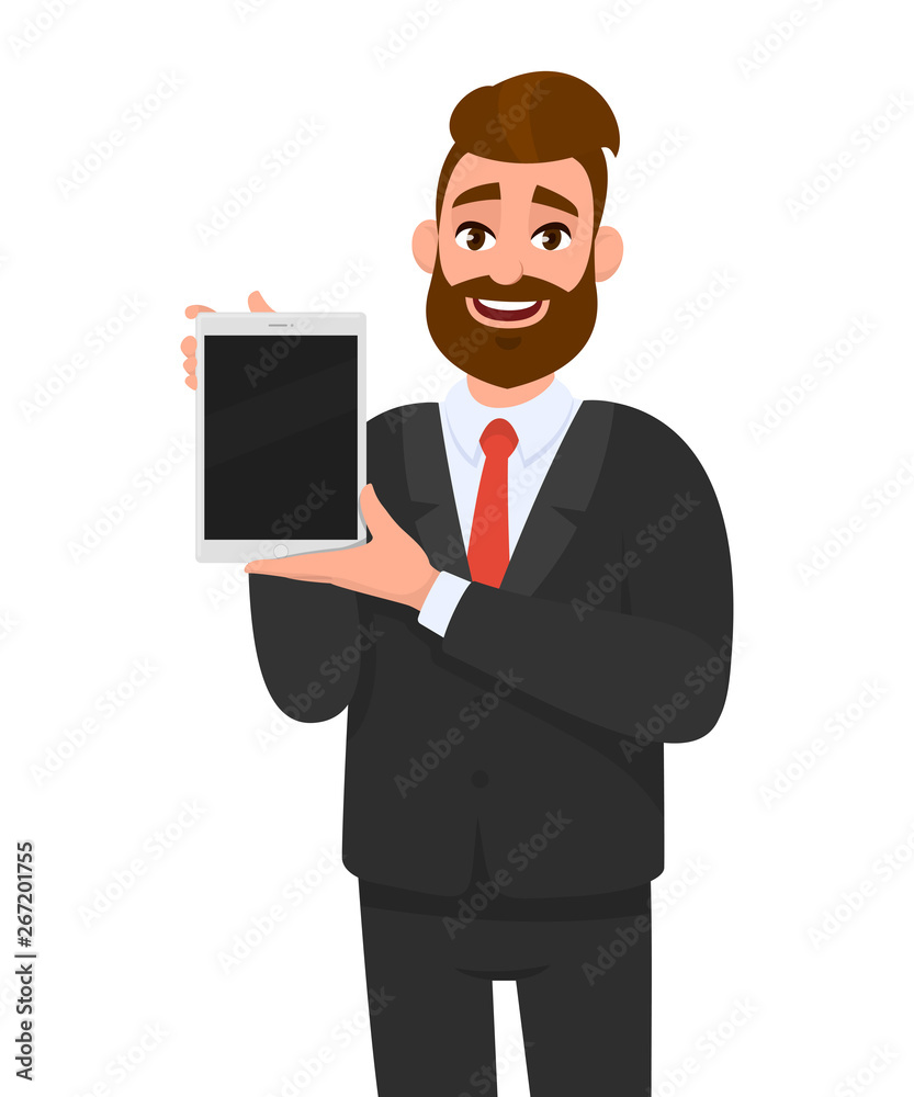 Trendy bearded business man showing/holding blank screen of digital tablet computer in hands. Millennial young man presents/introduces app, application from new digital pad. Modern technology concept.