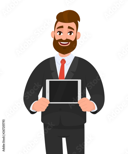Trendy happy young bearded business man showing/holding blank screen of digital tablet computer in hands. Modern technology, latest trends, digital gadget and device concept illustration in cartoon.
