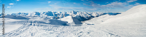 Panoramic view down snow covered valley in alpine mountain range