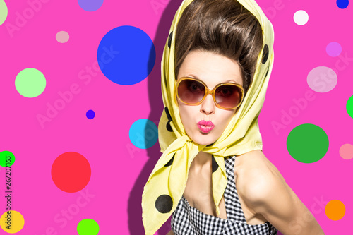 Cute retro woman wearing sunglasses over vibrant pink background. Party fashion look