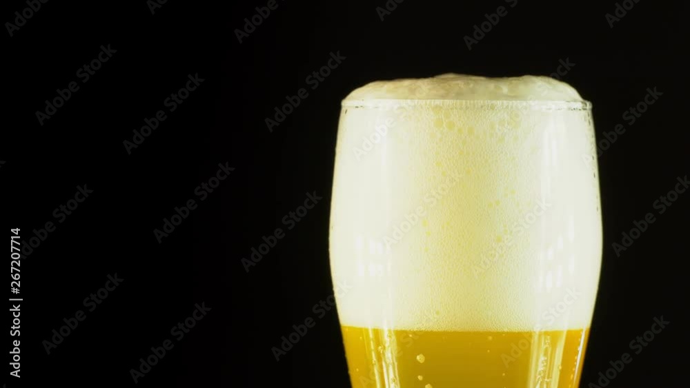 Cold Light Beer in a glass with water drops. Craft Beer close up. Rotation 360 degrees. 4K UHD video 3840x2160.There are no people. Cold Light Beer in a glass with water drops. Craft Beer close up. Rotation 360 degrees. 4K UHD video 3840x2160.There are no people.