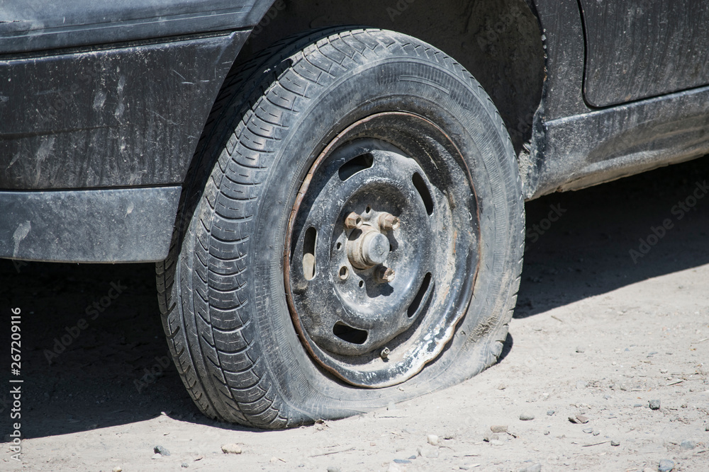 Flat tire while driving on the off-road. Flat tire while driving on the off-road.