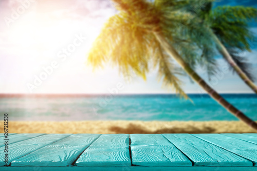 Fototapeta Naklejka Na Ścianę i Meble -  Summer background of wooden table and beach background with palms 