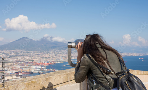 Woman looking at coin operated binocular