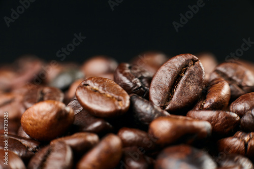 Roasted coffee beans on dark background. Close up