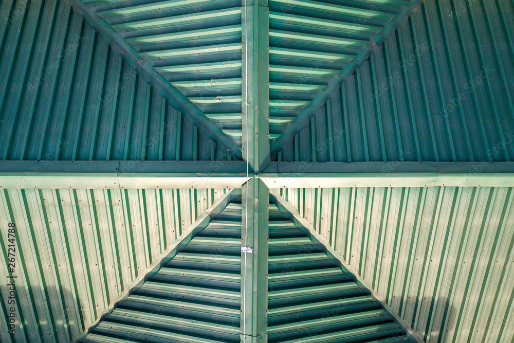 Naklejka premium Top aerial view of building green shingle tiled roof construction. Abstract background, geometrical pattern.