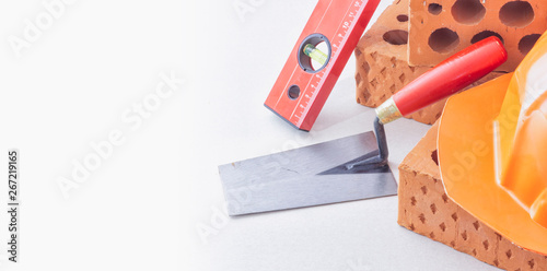 Construction hand tools trowel and bricks