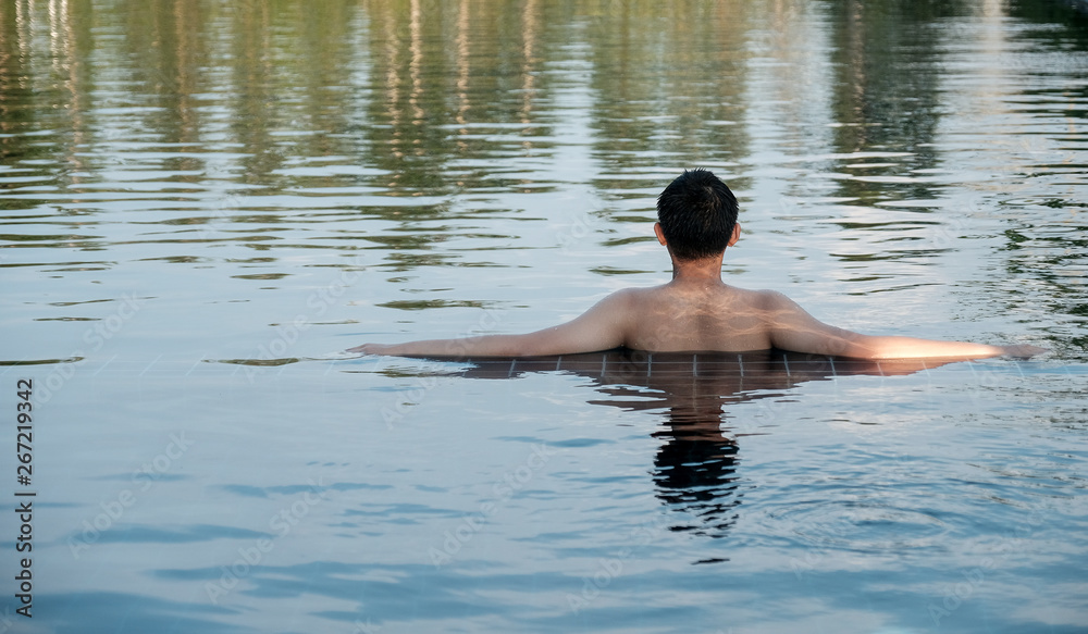 Fototapeta premium Boy sat in the pool on a hot day.