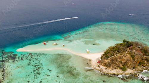 Tropical island with white beach. Bulog Dos, Philippines, Palawan. Seascape bay with turquoise water and coral reef aerial view