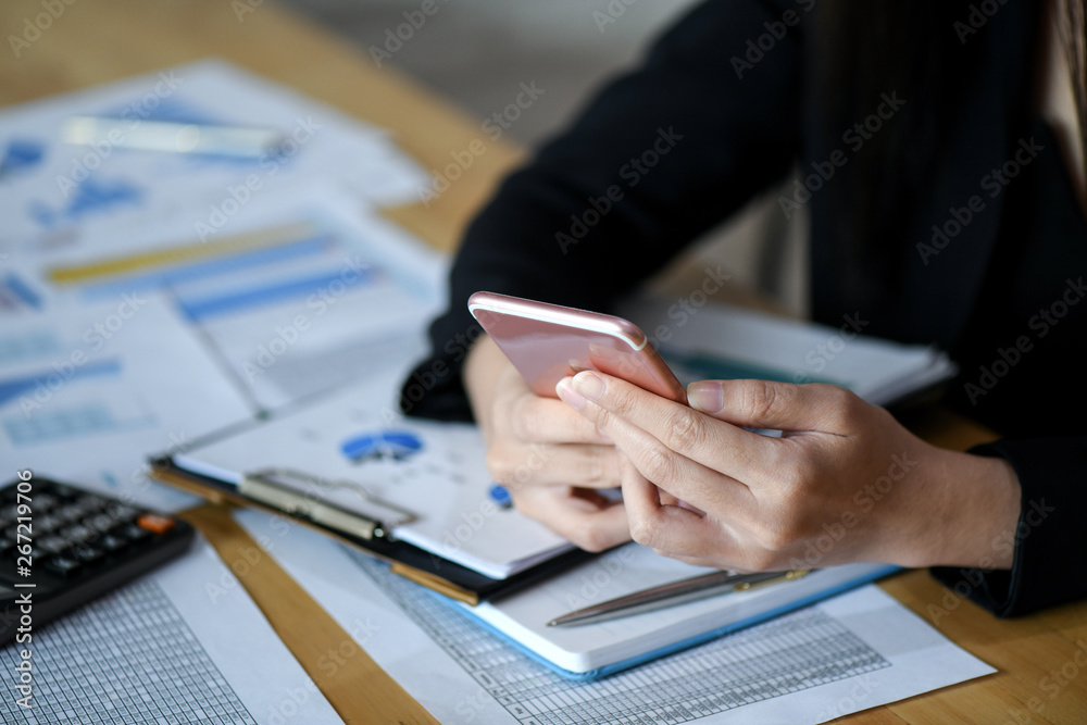 Female executives are using smartphone in the office. Female executives are using smartphone in the office.