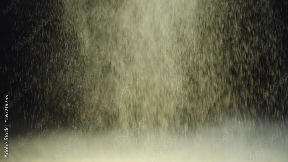 slow motion shoot of two cosmetic brushes touching and making splash of yellow holi paint and then powder falling slowly down