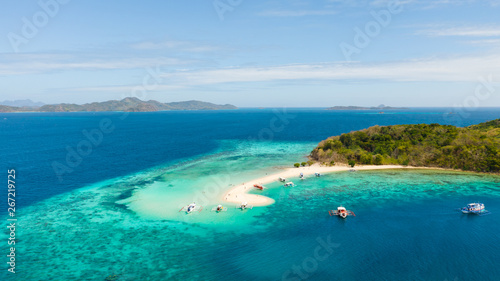 aerial seascape tropical island with sand bar, turquoise water and coral reef. Ditaytayan, Palawan, Philippines. tourist boats on tropical beach. Travel tropical concept. Palawan, Philippines