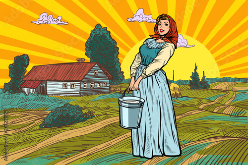 rural woman with a bucket of water or milk. farm landscape
