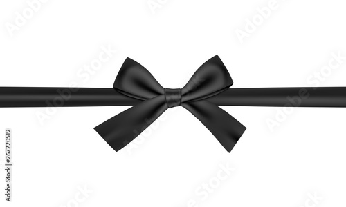 Black gift ribbon and bow on black background.