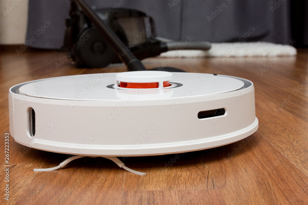 Comparing an old vacuum cleaner with an automated smart cleaning robot Comparing an old vacuum cleaner with an automated smart cleaning robot
