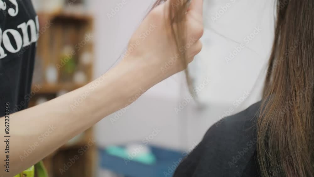Professional woman hairdresser making creative hairstyle to girl in beauty salon. Professional woman hairdresser making creative hairstyle to girl in beauty salon.