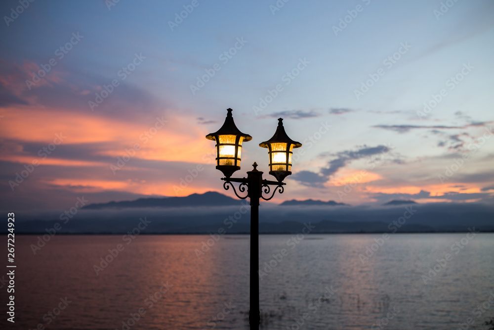 Obraz premium light lantern in mountain background and twilight darkness after sunset time romantic atmospheric.