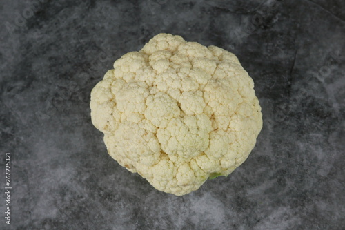 Top view of cauliflower on grey,black and white floor.