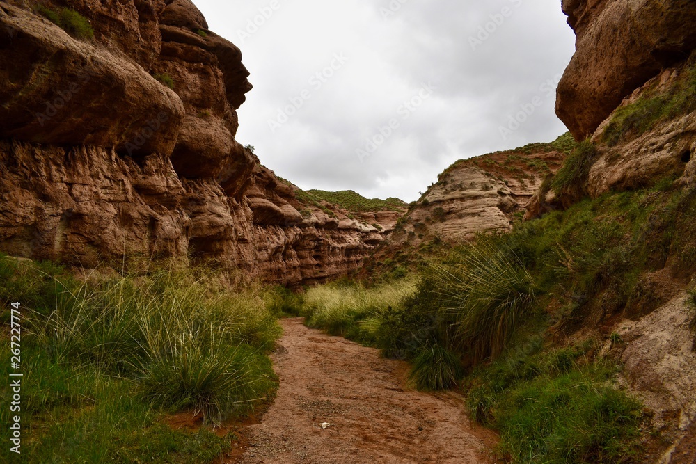 Narrow walking path between sandstones in Pingshan Grand Canyon National Park in Gansu province, China