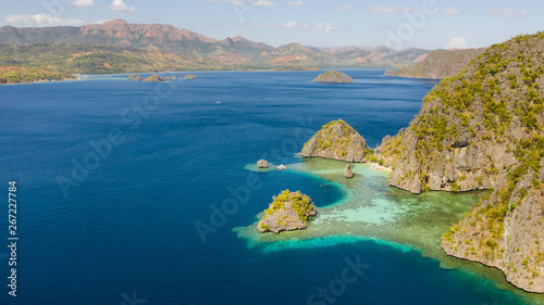 Tropical islands of the Malay Archipelago. Many islands with turquoise lagoons and coral reefs aerial view. Philippines, Palawan