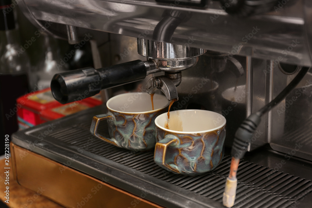 Preparing fresh aromatic coffee using modern machine at cafe Preparing fresh aromatic coffee using modern machine at cafe