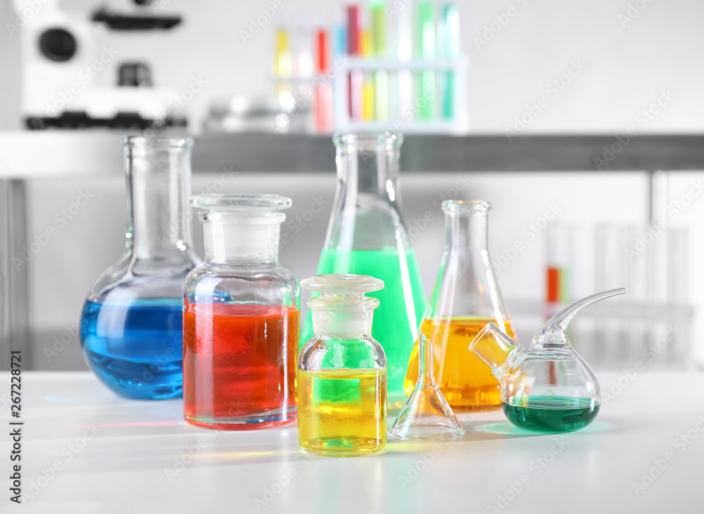 Different glassware with samples on table in chemistry laboratory Different glassware with samples on table in chemistry laboratory