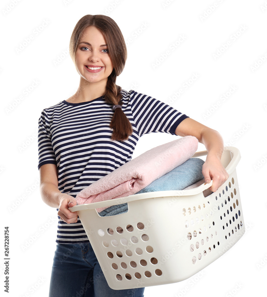 Happy young woman holding basket with laundry on white background Happy young woman holding basket with laundry on white background