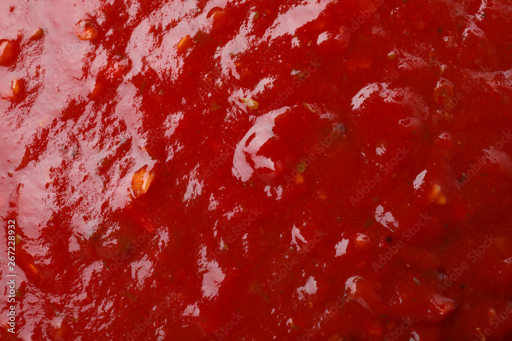 Tasty red spicy sauce as background, closeup Tasty red spicy sauce as background, closeup