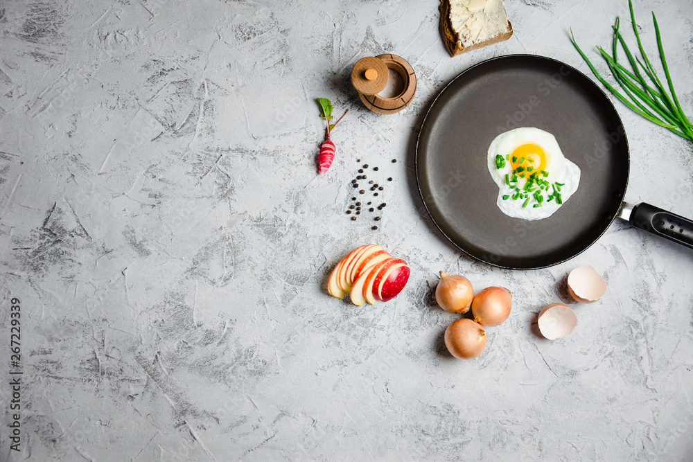 Fried egg on light concrete background Fried egg on light concrete background