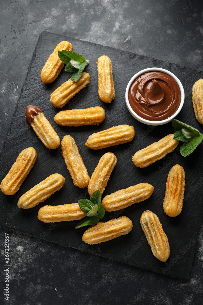 Churros with chocolate dipping sauce. sugar and cinnamon. Churros with chocolate dipping sauce. sugar and cinnamon.