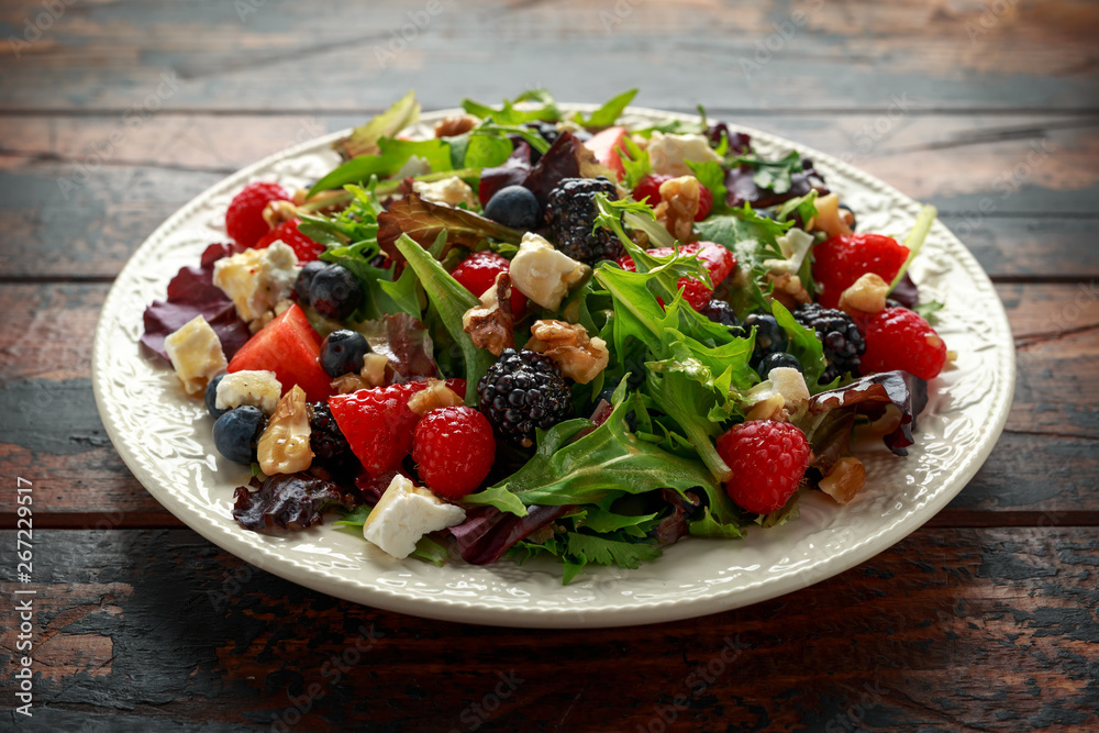Fresh Fruit Salad with blueberry, strawberry raspberry, walnuts, feta cheese and green vegetables. healthy summer food Fresh Fruit Salad with blueberry, strawberry raspberry, walnuts, feta cheese and green vegetables. healthy summer food