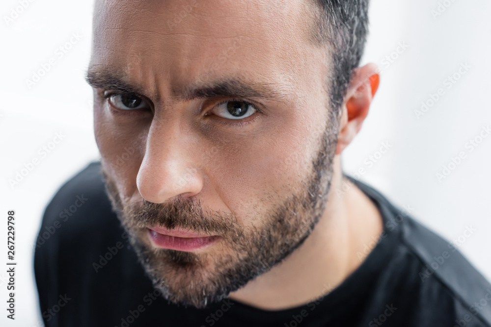 portrait of serious, handsome bearded man looking at camera portrait of serious, handsome bearded man looking at camera
