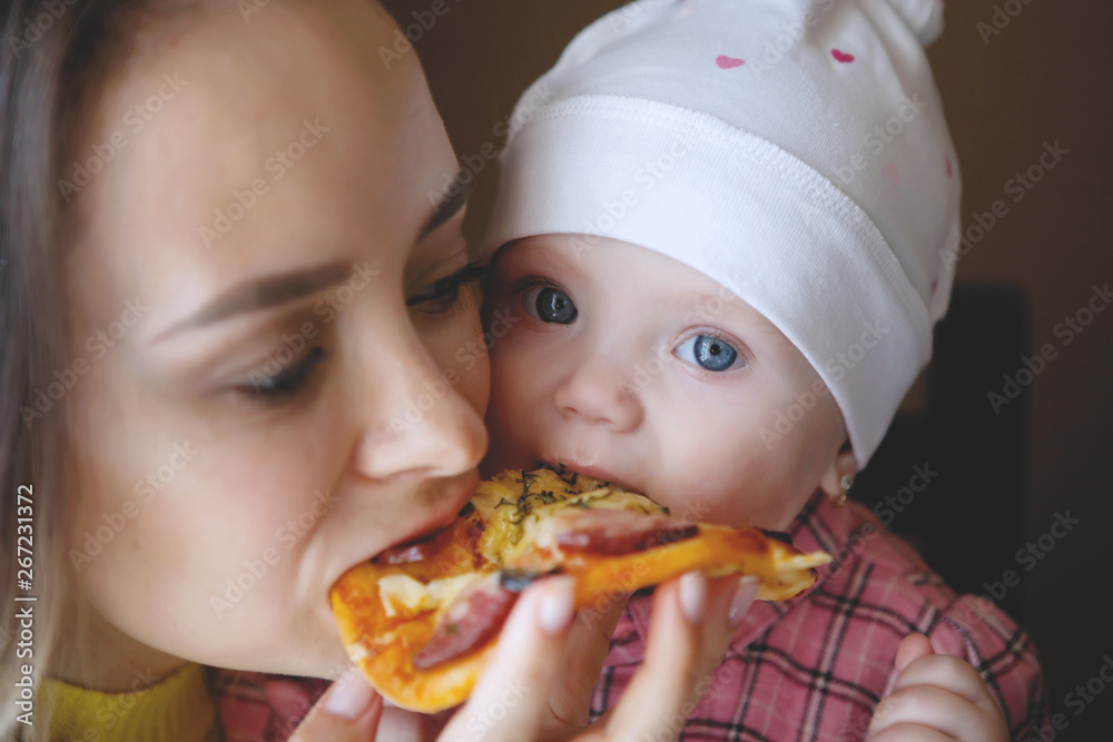 Mother eating with child.