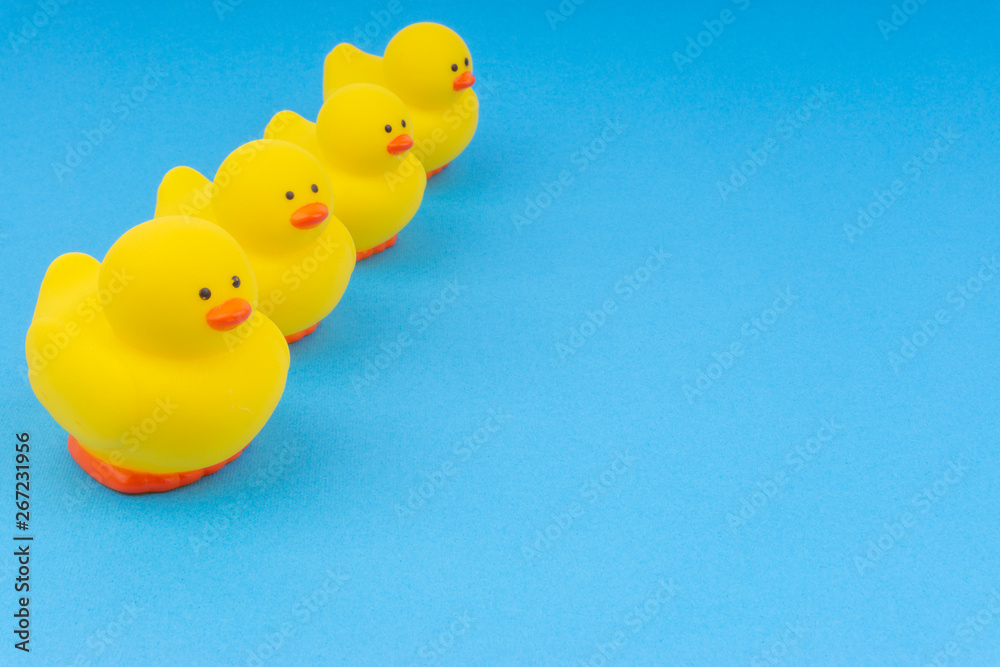 Yellow rubber duck on blue background. Selective focus and copy space concept Yellow rubber duck on blue background. Selective focus and copy space concept